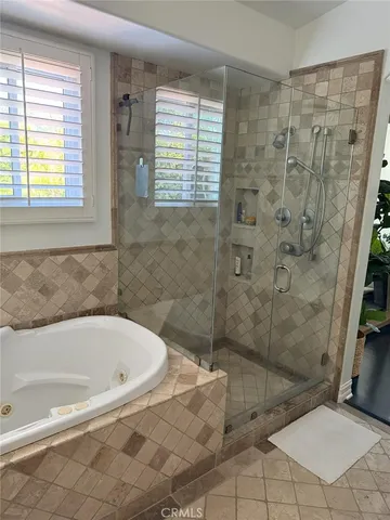 a bathroom with a bathtub and shower