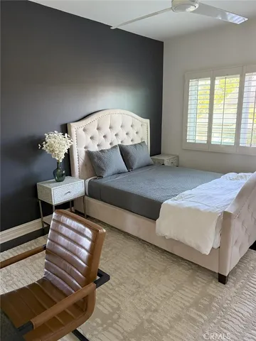 a spacious bedroom with a bed and window