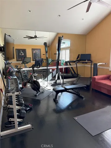 a room with gym equipment and a large window