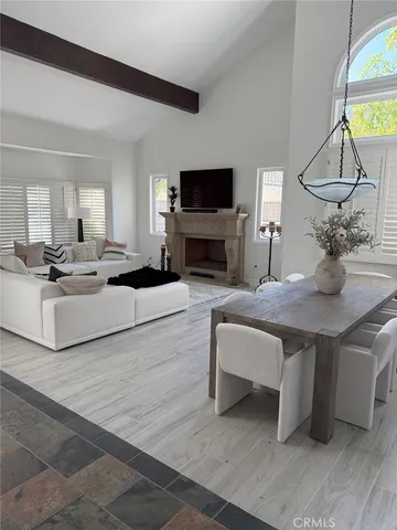 a living room with fireplace furniture and a flat screen tv