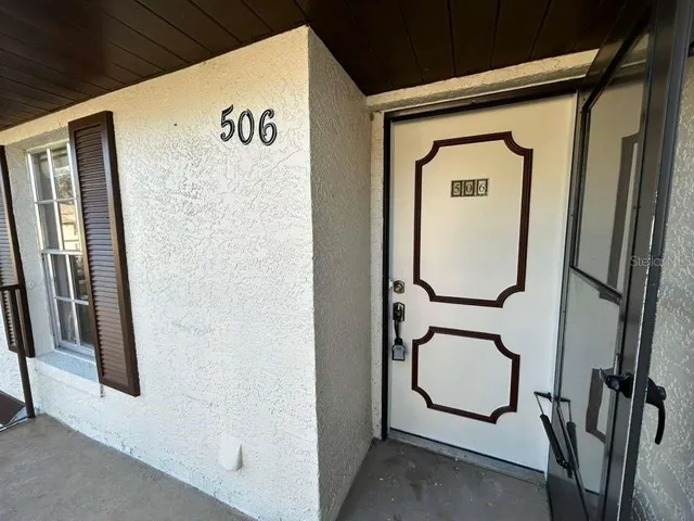 a view of front door with wooden floor