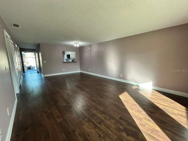 a view of a room with wooden floor