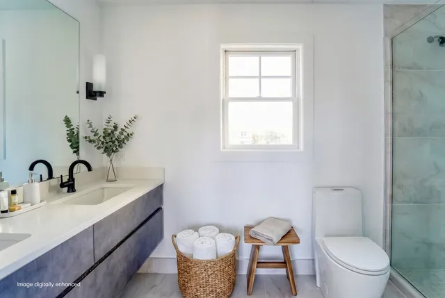 a bathroom with a toilet a sink and a window