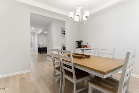 a large kitchen with a table and chairs in it