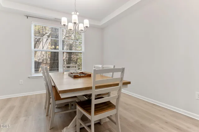 a kitchen with white cabinets and appliances