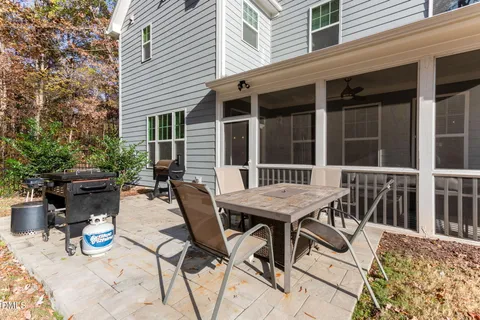a living room with flat screen tv and kitchen view