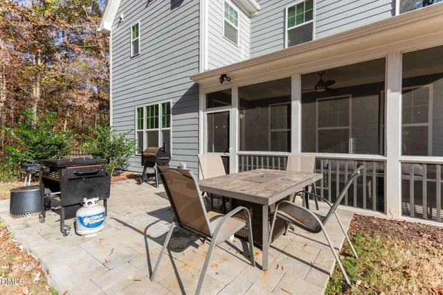 a living room with flat screen tv and kitchen view