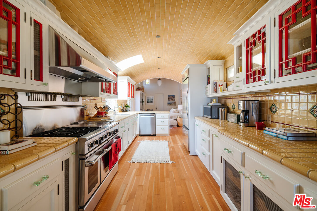 35145 Beach Road Dana Point, CA 92624 - Photo 23 of 57 a kitchen with stainless steel appliances granite countertop a stove and a wooden cabinets
