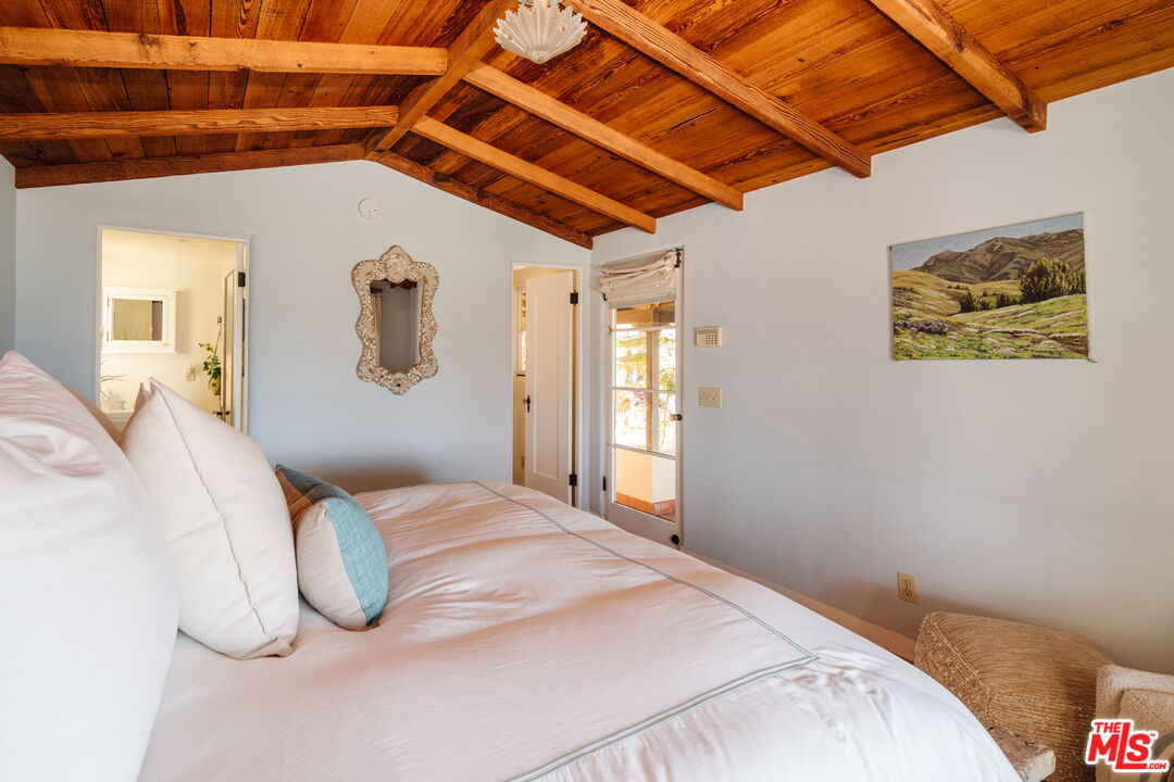 35145 Beach Road Dana Point, CA 92624 - Photo 29 of 57 a bedroom with a bed and a painting on the wall