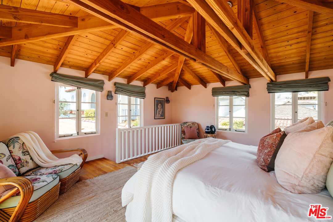 35145 Beach Road Dana Point, CA 92624 - Photo 37 of 57 a spacious bedroom with a bed and wooden floor