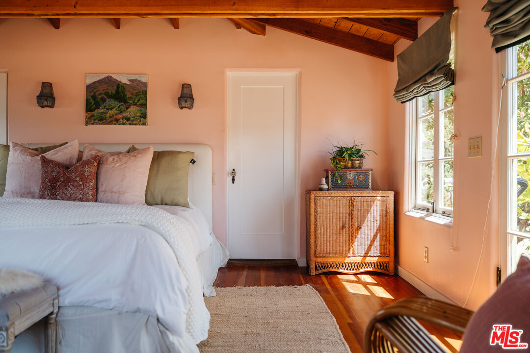 35145 Beach Road Dana Point, CA 92624 - Photo 39 of 57 a bedroom with a bed and wooden floor