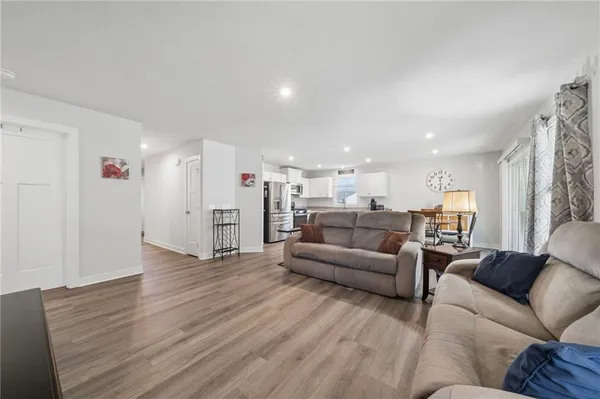 a kitchen with granite countertop a sink stove and refrigerator