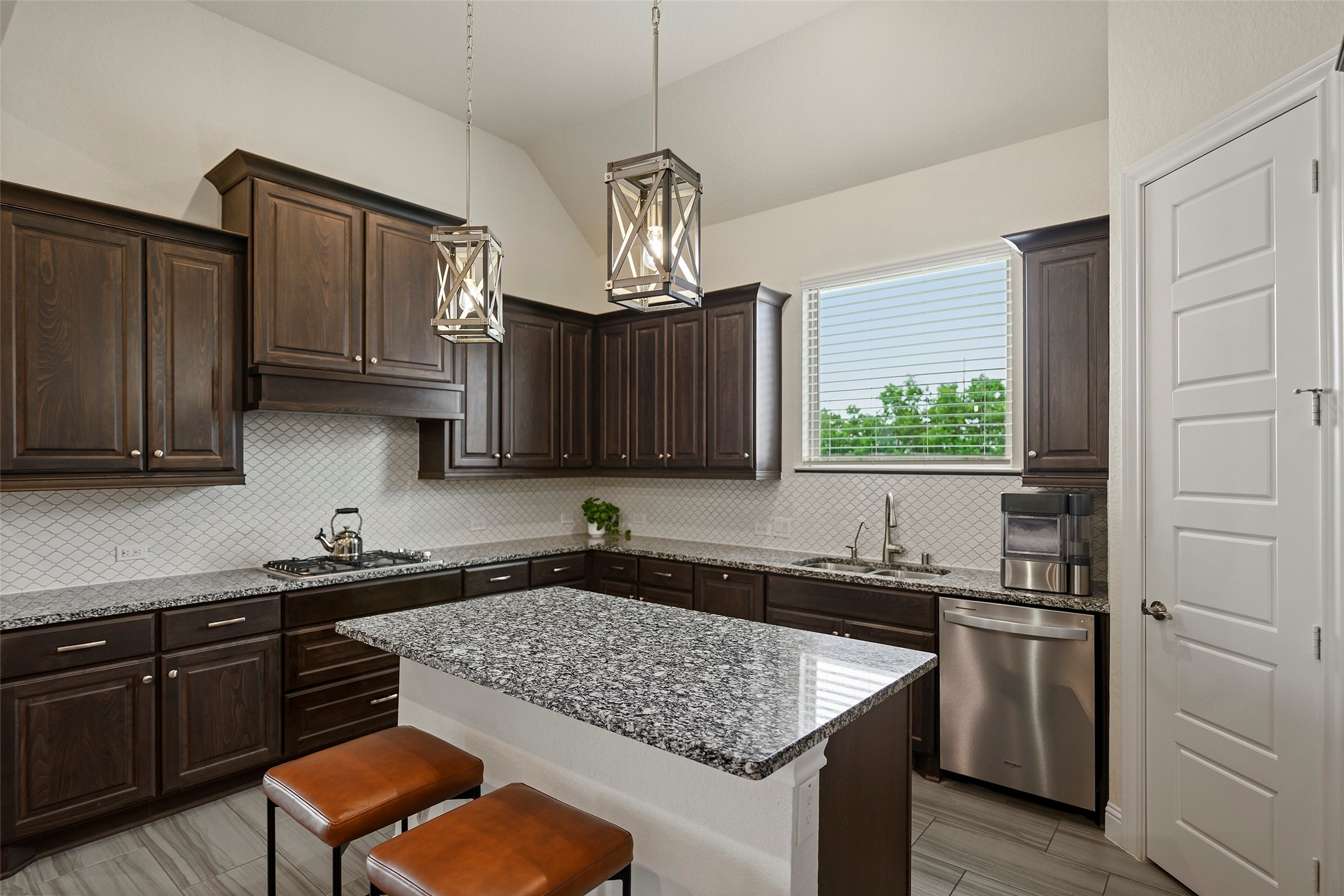 20330 Rosegold Way Spring, TX 77379 - Photo 39 of 48 Spacious kitchen featuring abundant cabinetry, granite countertops, designer pendant lighting, and a large center island with seating.