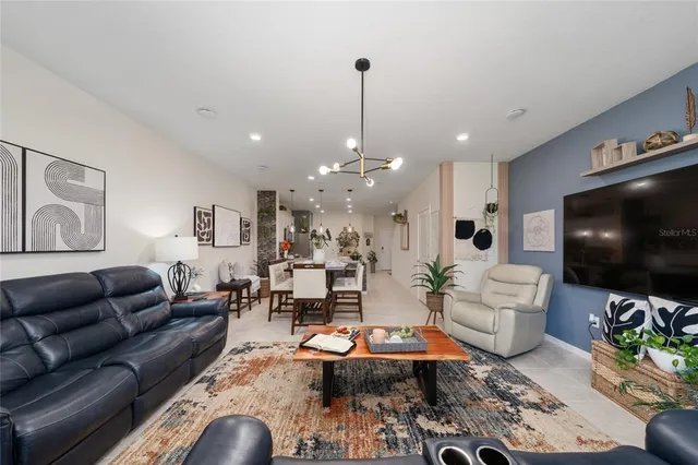 a living room with furniture and a chandelier