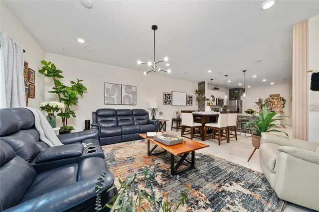 a view of living room filled with furniture and a potted plant