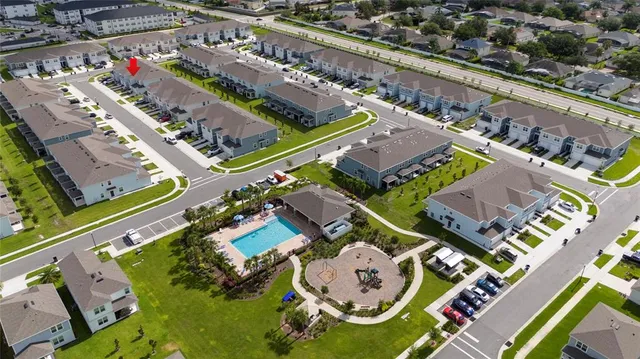 an aerial view of a house a yard and outdoor seating