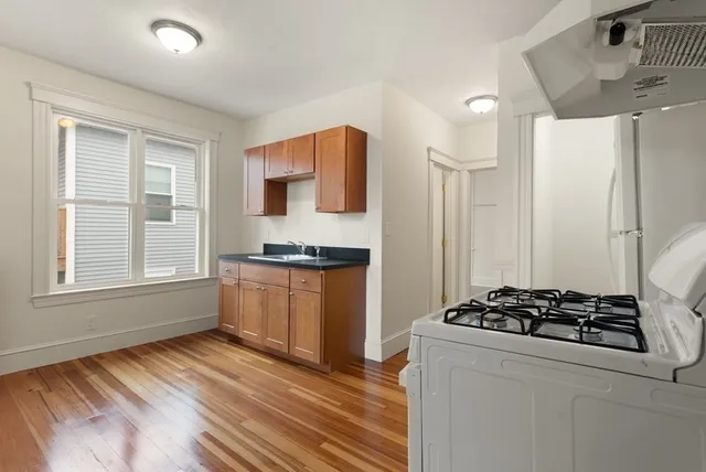 a kitchen with stainless steel appliances a refrigerator and a stove top oven