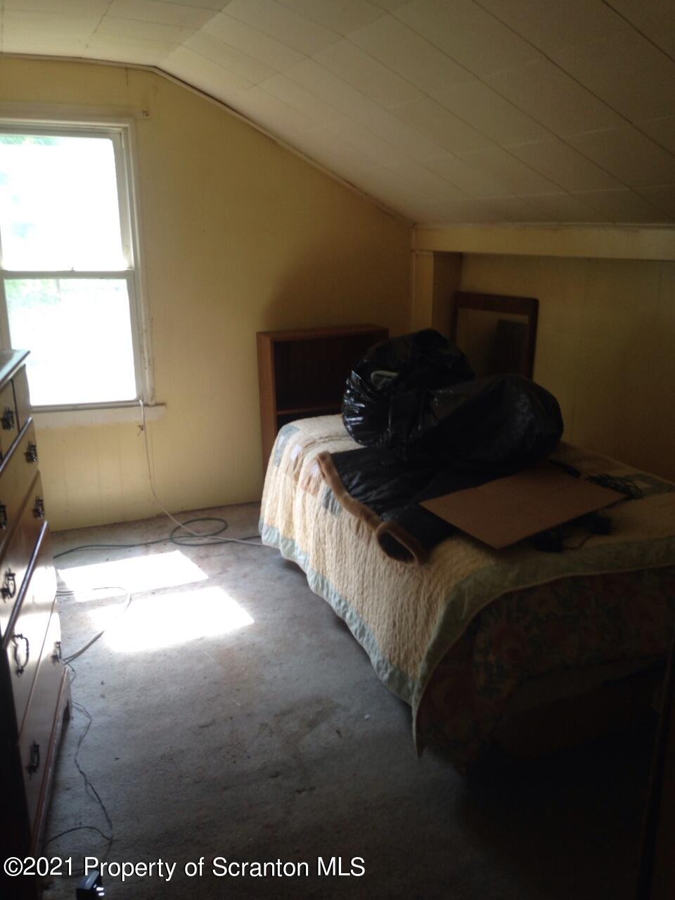 1707 Blaisure Road Montrose, PA 18801 - Photo 15 of 20 a bed sitting in a bedroom next to a window