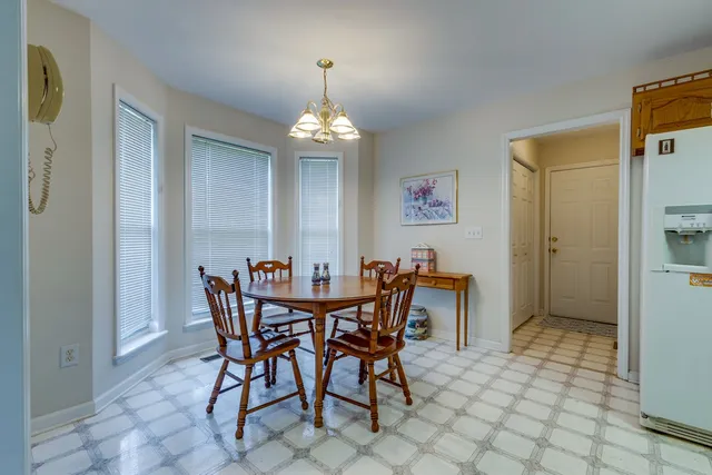a view of a dining room with furniture and chandelier