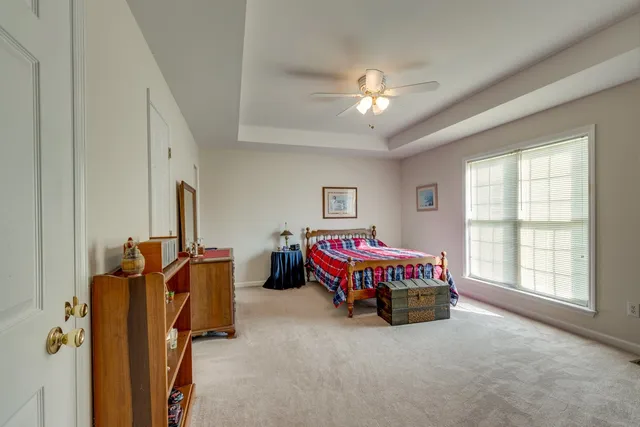 a spacious bedroom with a bed and a large window