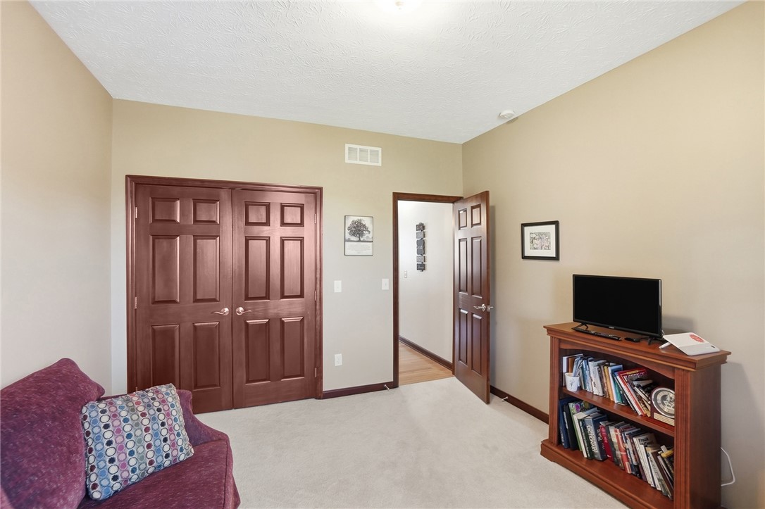 710 Governors Road Troy, OH 45373 - Photo 23 of 56 This cozy space features plush carpeting and classic wooden doors, ideal for relaxation or productivity.