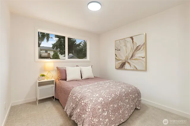 a bedroom with a bed and a painting on the wall