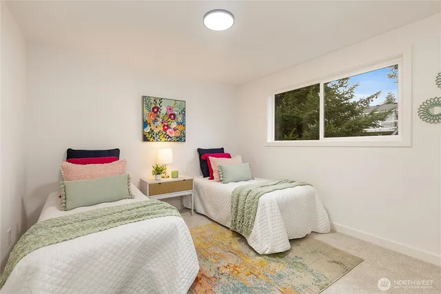 a bedroom with a bed and a painting on the wall