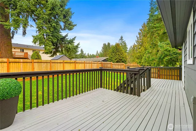 a view of balcony with wooden floor and fence
