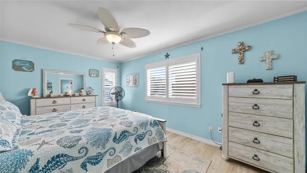 a bedroom with a large bed and a chandelier