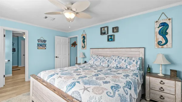 a bedroom with a bed and a chandelier