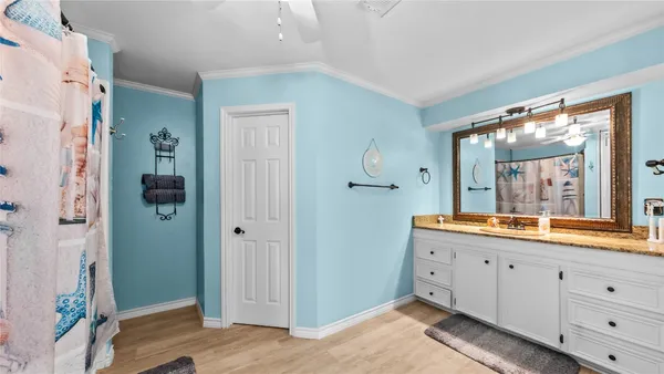 a spacious bathroom with a double vanity sink a mirror and a shower