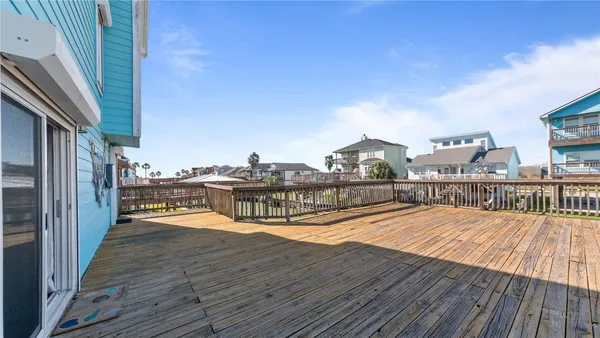 a balcony with hardwood filled with table and chairs