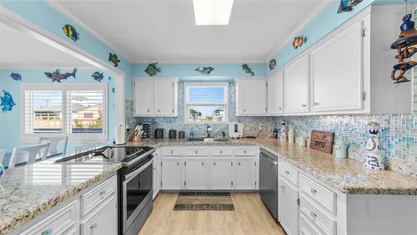 a kitchen with a sink stove top oven and cabinets