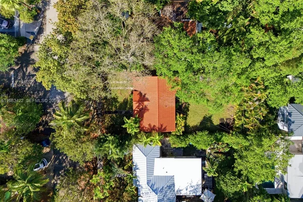 an aerial view of a house with a yard and garden