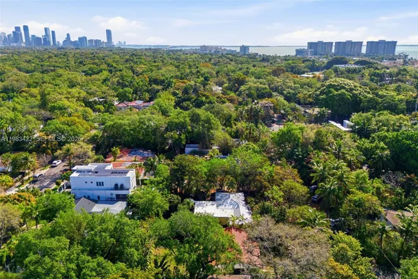 an aerial view of a house with a yard and lake view