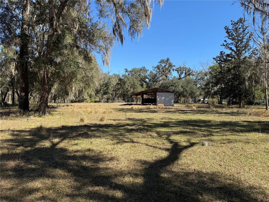 18630 Bradshaw Road Dade City, FL 33523 - Photo 16 of 43 a swimming pool with an outdoor seating