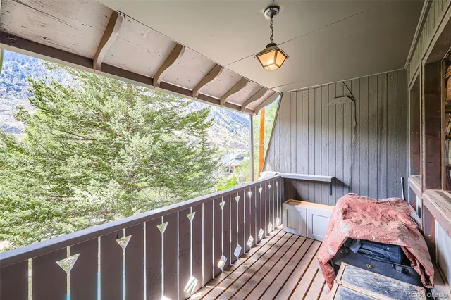 a balcony with wooden floor and outdoor space