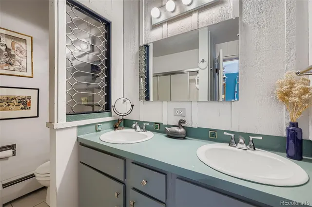 a bathroom with a sink double vanity and a mirror