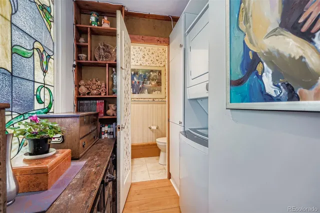 a view of a hallway with wooden floor and a potted plant