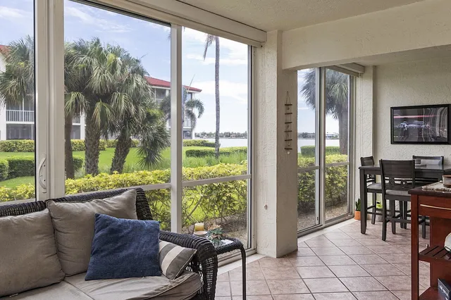 a living room with furniture and large windows