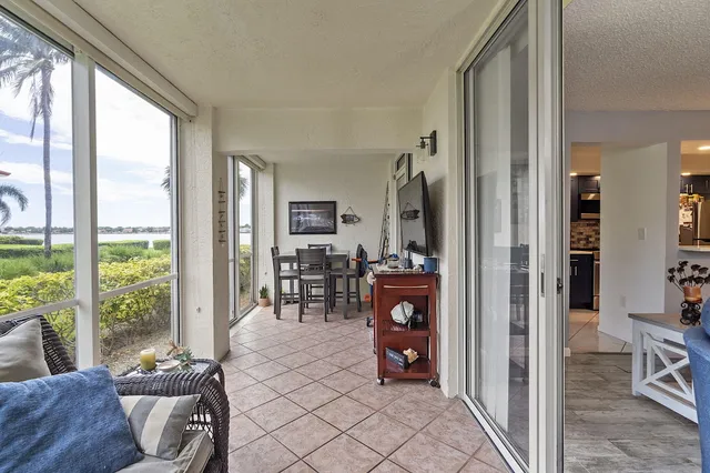 a living room with furniture and a floor to ceiling window