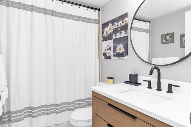 a bathroom with a sink vanity and a mirror