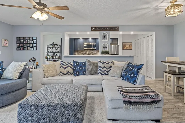 a living room with furniture and a chandelier