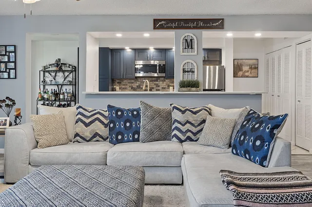 a living room with furniture kitchen and a couch