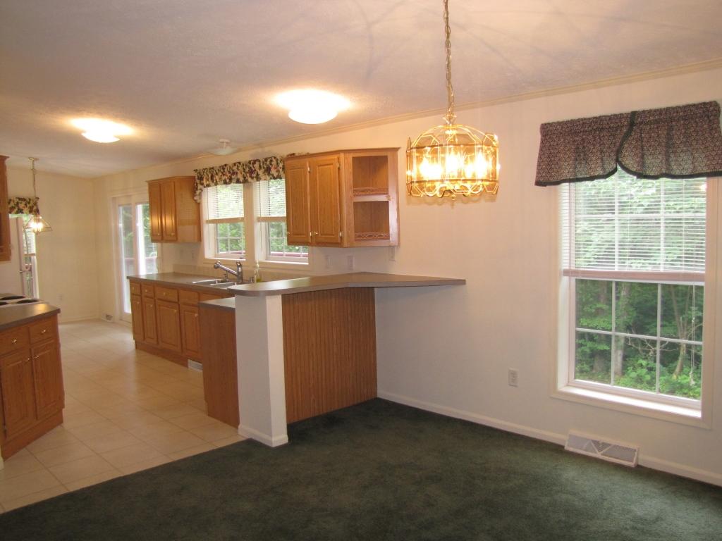 110 Old Post Road Moneta, VA 24121 - Photo 39 of 99 a kitchen with stainless steel appliances granite countertop a stove a sink and a chandelier