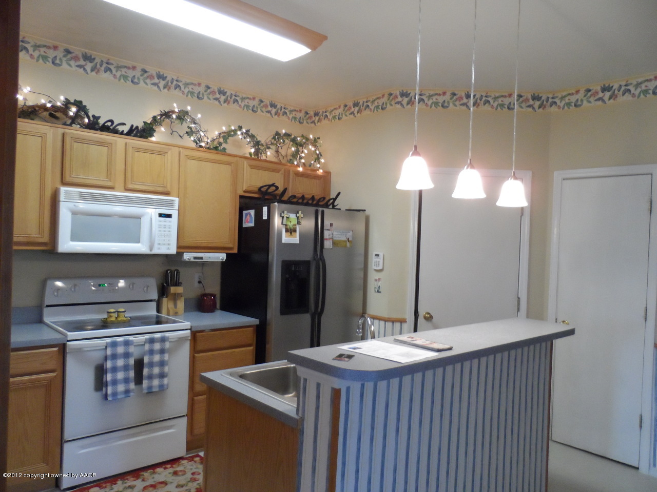 1173 Rushmore Drive Amarillo, TX 79110 - Photo 8 of 26 a kitchen with sink stove and refrigerator