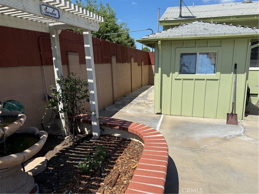 110 Rigsby Street La Habra, CA 90631 - Photo 30 of 41 A look on the side of house, small cabana, and planter with water fall.