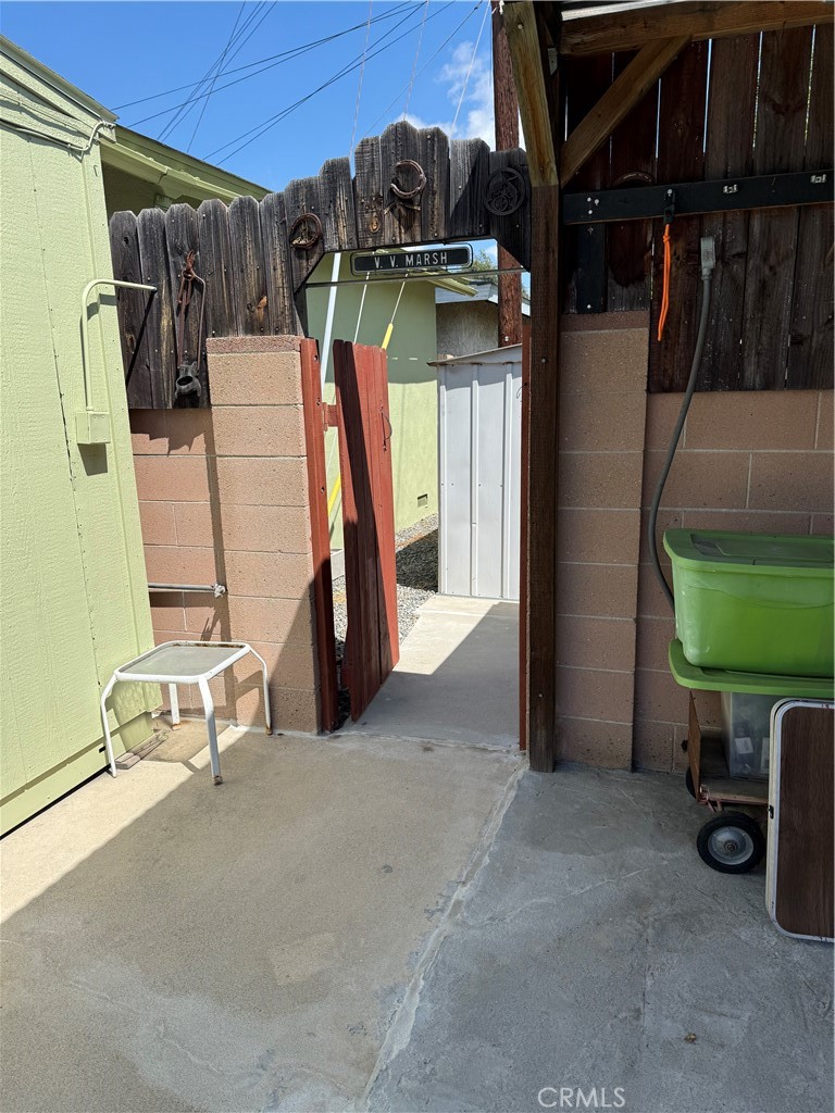 110 Rigsby Street La Habra, CA 90631 - Photo 37 of 41 Gate goes to small area behind the garage and out to creeek. with another small shed for storage