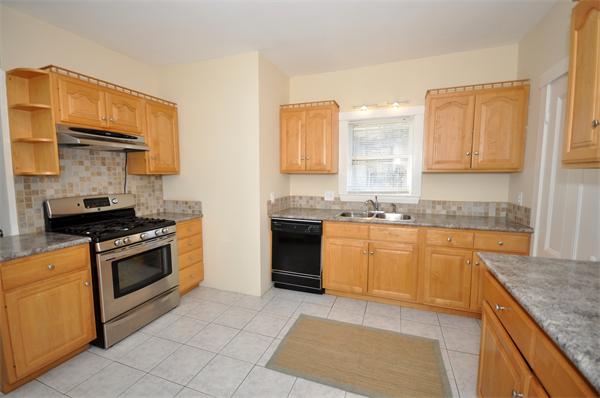 62 Central Street Framingham, MA 01701 - Photo 5 of 23 a kitchen with stainless steel appliances granite countertop a stove sink and cabinets