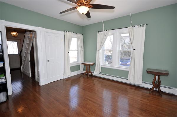 62 Central Street Framingham, MA 01701 - Photo 8 of 23 a view of an empty room with wooden floor and a window
